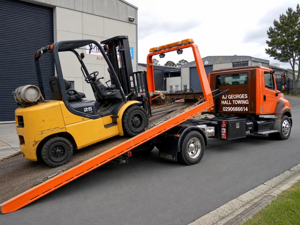 Forklift being loaded onto AJ Georges Hall Towing truck
