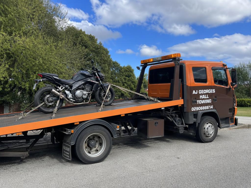 Motorbike secured on AJ Georges Hall Towing tilt tray